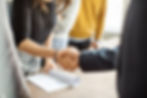 Two people shaking hands in the workplace